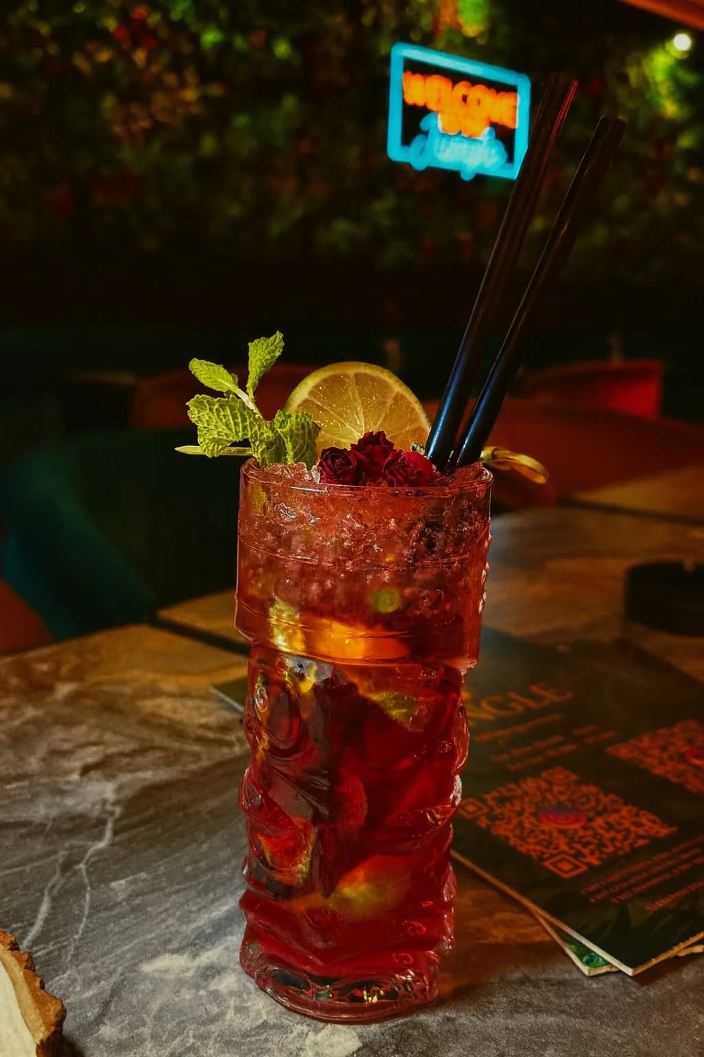 Strawberry Mojito with crushed ice, lime, fresh mint and rose buds in a tiki glass at Jungle cocktail bar Radolfzell at Lake Constance